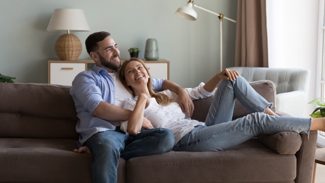 A pair sitting on a couch