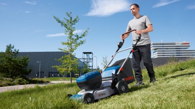 Powerful Bosch Professional cordless lawnmower and dual charger for faster charg ...